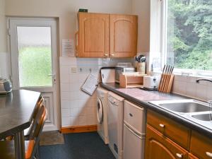 a kitchen with a sink and a dishwasher at Oak Lea in Braithwaite