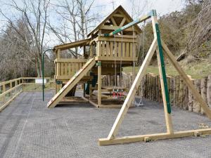 a wooden play house with a swing at Hollys Lodge - E4072 in Brough