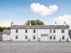 a white house with a lot of windows at Willow in Gatehouse of Fleet