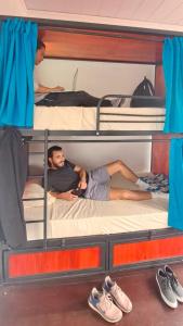 two men laying on bunk beds on a boat at Costa Rica Guesthouse in San José