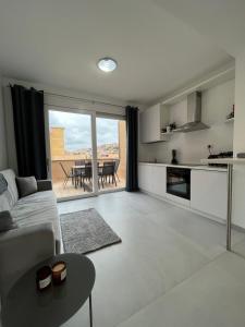 a living room with a couch and a table at Crabonaxa Suite Appartment in Villasimius