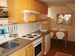 a kitchen with a sink and a stove top oven at Foxhole in Threlkeld