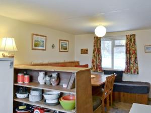 a kitchen with a table and a dining room at Tigh Na Caoiraich in Tomdoun