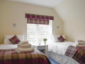 a bedroom with two beds and a window at Sandhaven in Culross