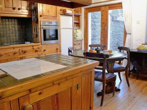 a kitchen with a island and a table in a kitchen at Cranesbill Barn in Ravenstonedale