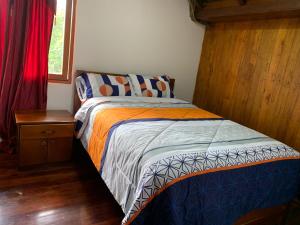 MacasにあるMY HOUSE IN MACASの小さなベッドルーム(ベッド1台、ナイトスタンド付)