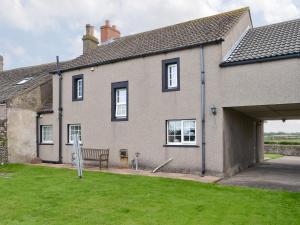 a house with a bench in front of it at Holmlea in Beckfoot