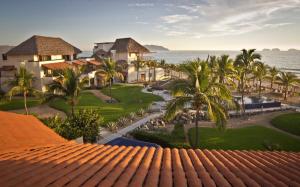 an aerial view of a resort with palm trees and the ocean at Residences at Las Palmas in Zihuatanejo