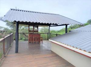 a wooden deck with a gazebo on a house at Tugela Mouth, Beach views in Tugela Mouth