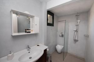 a white bathroom with a sink and a shower at Villa Endless Blue in Kalamitsi +45 photos