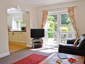 a living room with a couch and a television at Mole in Swimbridge