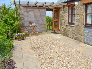 a patio with a table and a building at Sparrows in Morvah