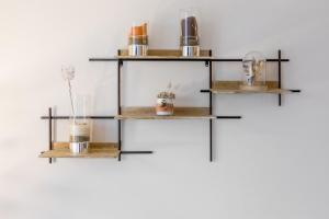 a shelf system with three tiers of glass and metals at Cosy flat in Monplaisir district in Lyon - Welkeys in Lyon