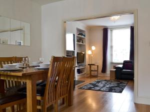 a dining room and living room with a table and chairs at Warner Lea in Bowness-on-Windermere