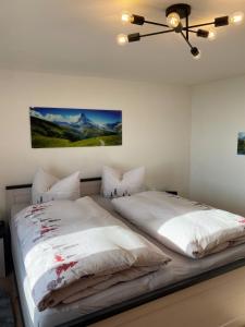 a bedroom with two beds and a painting on the wall at The Old Farmhouse in Edling