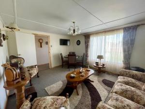 a living room with a couch and a table at Hospedaje Baquedano in Puerto Natales
