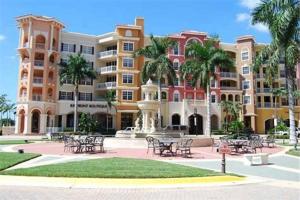 a building with tables and chairs in a courtyard at Casa Del Mare at the Beach 2 bd rms W King Beds in Naples