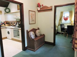 a living room with a kitchen and a mirror at Moorlands Cottage in Levisham