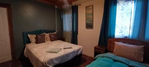 a small bedroom with a bed and a window at Lascar 31 in San Pedro de Atacama