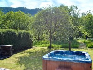 a hot tub in a yard with a tree at The Ranch in Benmore