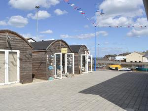 a building on a pier next to a marina at Seaside Retreat in Amble