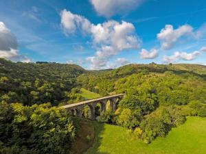 an aerial view of a bridge in the hills at Marl Farm Cottage in Hayfield