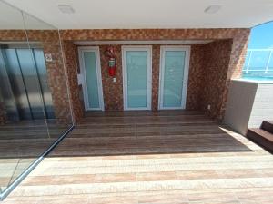 a view of the outside of a building with glass doors at Paradise Beach Flat - Pé na Areia Bessa in João Pessoa