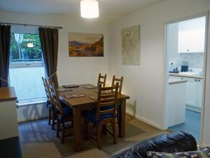 a dining room with a wooden table and chairs at Badger Cottage in Ambleside