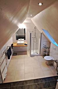 a large bathroom with a sink and a shower at Deichstube-Greetsiel in Krummhörn +14 photos