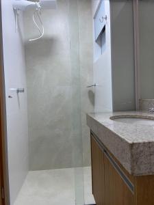 a bathroom with a shower with a glass door at Condomínio Recanto do Bosque - RBF-10 in Caldas Novas
