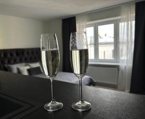 two glasses of champagne are sitting on a table at TEATRA Apartamenti in Liepāja +11 photos