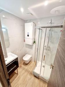 a bathroom with a shower and a toilet and a sink at Appartement Moderne Neuf F2 Centre ville in Valence +20 photos