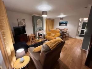 a living room with a couch and a fireplace at Lovely Stylish 3 Bed House with Free Parking in Norwich