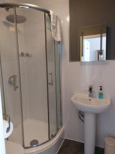 a bathroom with a shower and a sink at The Norwood in Torquay
