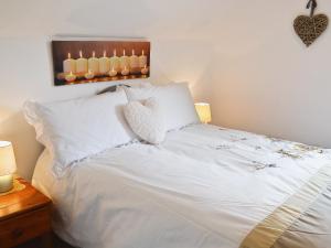 a bedroom with a white bed with two white pillows at Addylea - 16312 in Bowland Bridge