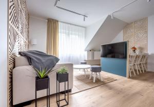 a living room with a couch and a dining room at Apartmány u Lesa in Dolní Morava