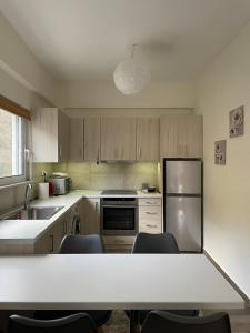 a kitchen with wooden cabinets and a table with chairs at Villa Eva 2 