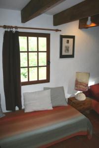 a bedroom with a bed and a window at Le gite panda saint-maymes in Trigance