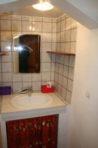 a person taking a picture of a bathroom sink at Le gite panda saint-maymes in Trigance