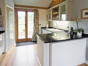 a kitchen with a sink and a counter top at Little Gable in Berrington