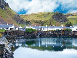 a village on the side of a river with houses at Old Brewery Cottage - S4576 in Ellanbeich