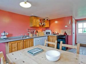 a kitchen with a wooden table with a bowl on it at Holy Boys - 17626 in Castle Acre