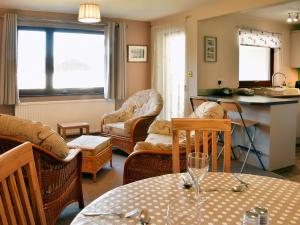 a living room with a table and chairs at Briarwood in Bowness-on-Windermere