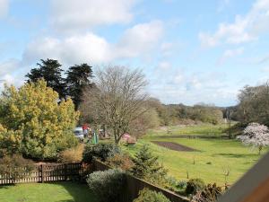 a view of a yard with a fence and a field at Swallow Cottage in Shanklin