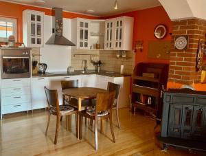 a kitchen with a table and chairs and a stove at Kula hacienda in Tuzla