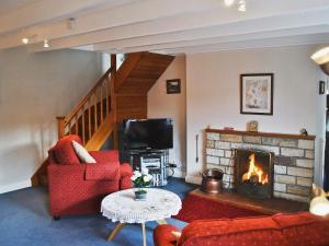 a living room with a couch and a fireplace at Sunnyside in Sandsend