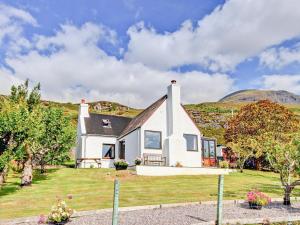 a white house with a hill in the background at Clachan in Torridon