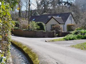 a house with a road in front of a house at Mill Haven in Dunster
