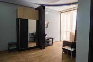 a living room with a large mirror and a chair at Gudauri Club 2100 Apt206 in Gudauri