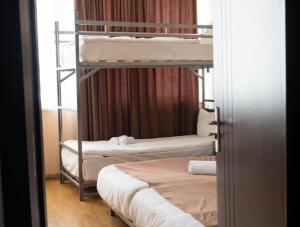 a room with two bunk beds and a bed at Gudauri Club 2100 Apt206 in Gudauri
